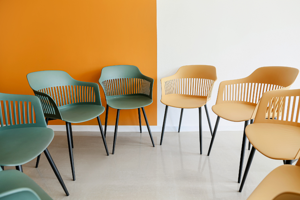 A row of chairs in front of an orange wall, Michelle Gibbings, emotional intelligence at work