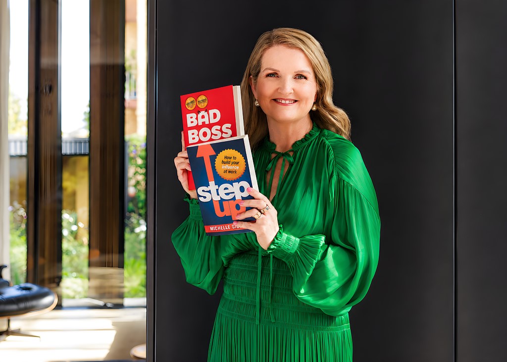Michelle Gibbings holding her Bad Boss and Step Up books, author of the Conscious Change Leader Program